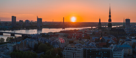 Aerial panoramic sunset over Riga old town in Latvia. Beautiful spring sunset over Riga. Golden...