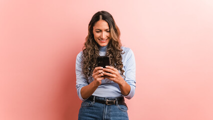 Smiling adult hispanic woman using mobile phone