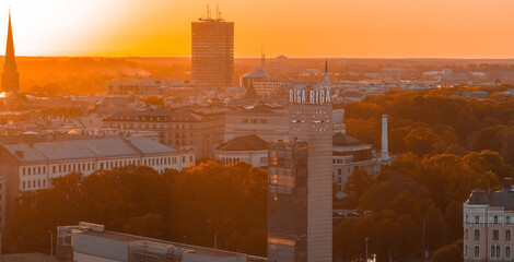Aerial panoramic sunset over Riga old town in Latvia. Beautiful spring sunset over Riga. Riga clock...