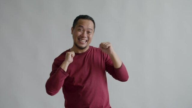 Asian Man Enjoy Dancing, Move Body Attractively Isolated On Gray Background 