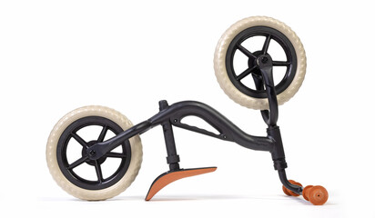 Modern black balace bike for a small child, isolated