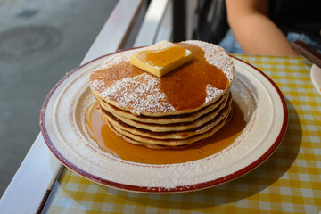 pancake and syrup poured close up