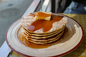 pancake and syrup poured close up