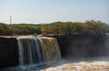 Waterfall at Jingbo Lake Scenic Area in Mudanjiang, Heilongjiang, China in autumn