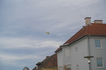 Background with small helicopter and house roofs.