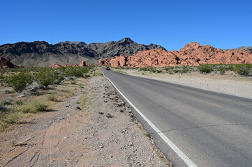 Road running through The Valley of Fire state park on a scorching April day in 2024.