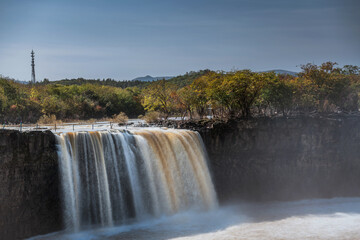 Waterfall at Jingbo Lake Scenic Area in Mudanjiang, Heilongjiang, China in autumn