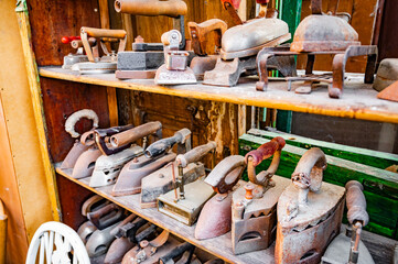 old iron irons. Antique store, flea market, junk and vintage items.