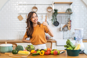 Portrait happy beauty slim healthy asian woman and vegan food healthy fresh vegetable and fruit in kitchen.diet, vegetarian, eating, fruit, wellness, health, green food.Fitness, healthy food