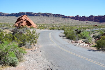 Road running through The Valley of Fire state park on a scorching April day in 2024.