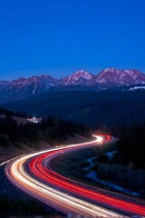 busy highway winding through a mountain range with dynamic flow of vehicles headlight