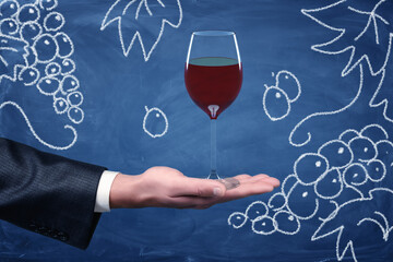 Hand offering wine glass drawing on chalkboard