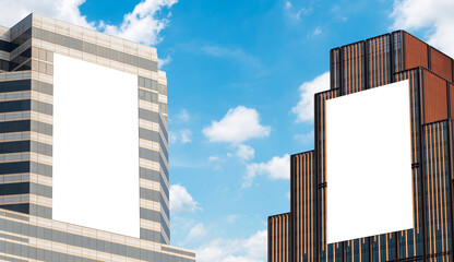 Two outdoor vertical billboard on building  with blue sky background