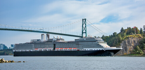 Huge ocean cruise ship passing under famous Lion Gates Bridge. Vancouver, Canada