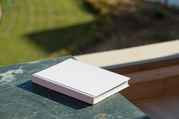blank book mockup on green marble stone coffee table , shadow overlay