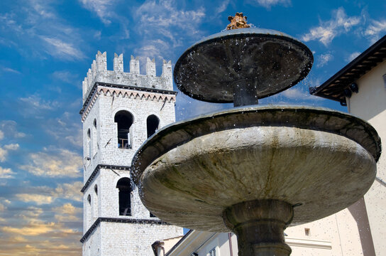 Piazza fountain in Italy at sunset.