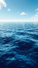 Fototapeta premium Deep blue ocean with white clouds in the sky