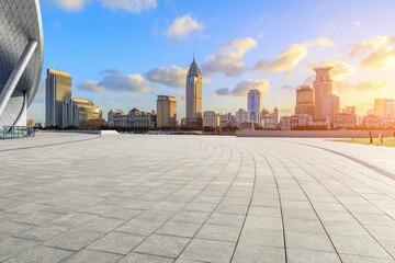 Empty square floor and modern city buildings at sunset in Shanghai. Famous Bund landmark in China.