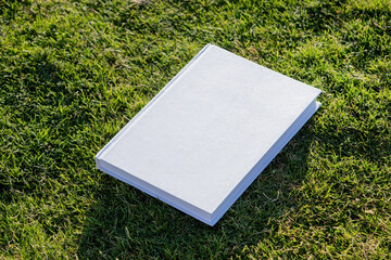 Mockup book on green grass background