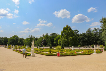 An elderly man explores the beautiful palace gardens in Białystok, summer 2023, Poland, Podlaskie Voivodeship