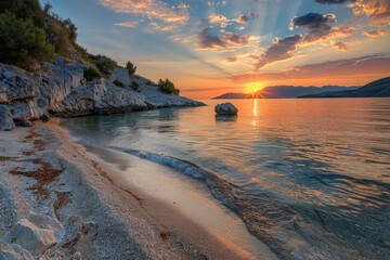 Obraz premium Rocky coastline with sunset and tranquil waves