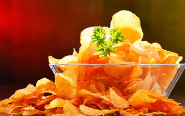 Composition with bowl of potato chips.