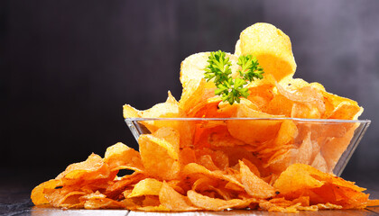 Composition with bowl of potato chips.