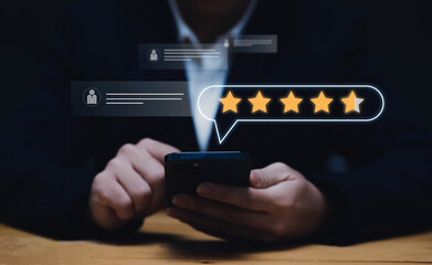 Businessman using smartphone giving online customer reviews giving stars evaluating product shop, services entertainment, application and software. Standard quality control customers satisfaction.