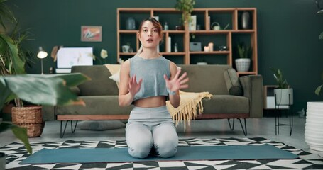 Woman, yoga and tutorial with influencer on mat in living room for exercise, workout or pilates at home. Portrait of young female person, vlogger or yogi talking for healthy tips, fitness or wellness