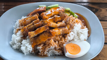 Crispy pork rice on a blue plate on the dining table