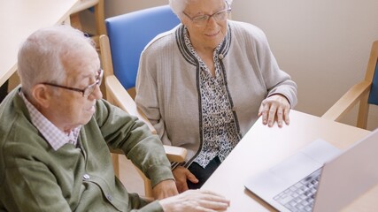 Grandparents using laptop during a video call