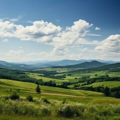 Fototapeta premium idyllic green rolling hills landscape under blue sky with white clouds