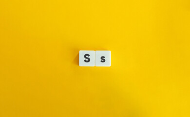 Capital and Small Letter S. Uppercase and Lowercase Letter. Concept of Learning Alphabet. Text on Block Letter Tiles against Yellow Orange Background.