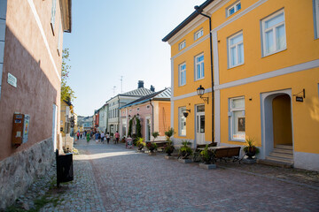 Porvoo, Finland. Narrow streets of Old town of Porvoo. Picturesque colorful wooden houses. Historic center, touristic place, landmark of Finland. Warm sunny summer day in nordic country.