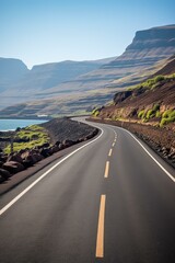 Curving Road along the Coastline with Rocky Mountains in the Distance