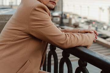 Street style details of brown beige men's coat. Classic outerwear