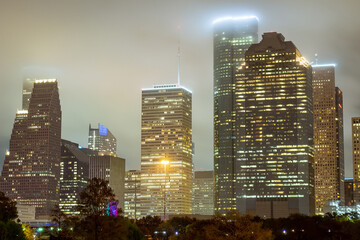 Houston Texas downtown city skyline illuminated buildings. Photo taken on a cloudy foggy evening