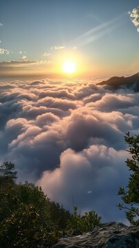 Amazing sunset view from the top of the mountain above the clouds