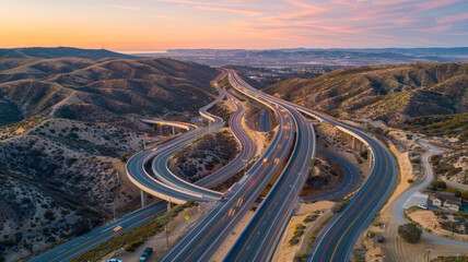 A highway with a lot of curves and a beautiful sunset in the background