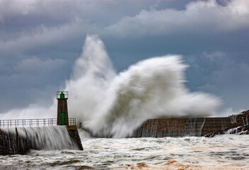 Impressive huge waves hitting the port of Viavelez in Asturias during a storm in the Cantabrian Sea