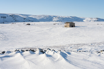 An abandoned old house on an arctic treeless uplands on a bright winter day, Berlevåg, Northern...