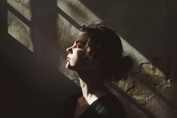 A woman with dark hair and a red nose is sitting in the sun