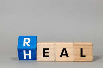 Fliped a wooden cube with words 'Real heal'.  Medical and real heal concept. Real heal symbol. copy space.