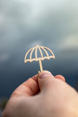 Man holding umbrella symbol, stormy rainy day, insurance concept, policy, life insurance, family protection