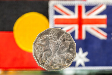 Aboriginal and Australian flag with 50 cent coin. Concept related to Australia - obrazy, fototapety, plakaty