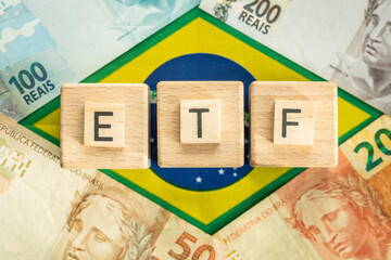 The word ETF for Exchange Traded Fund written on wooden cubes, symbol of Brazilian money