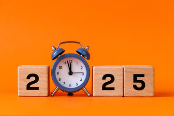 2025, Business concept, new year symbol. gray alarm clock counts down to 12. Beautiful orange background, copy space. 2025 happy new year