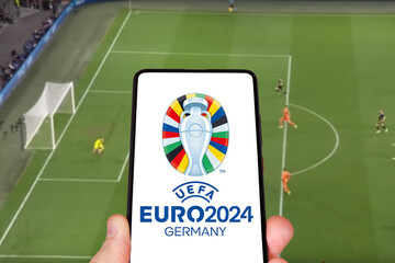 Fototapeta premium UEFA Euro 2024 Germany European Football Championship Europe logo on a mobile photomontage in Germany