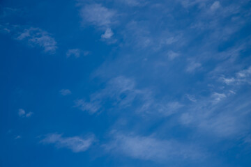 Blue sky with a few clouds background.