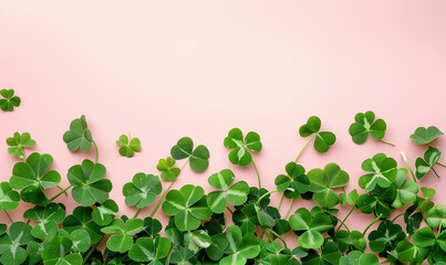 Fresh green clover composition in corners On a pastel pink background. Patrick's Day.